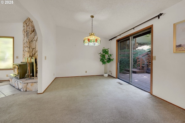 1770 W 28th Ave, Eugene, OR 97405 - unfurnished dining area with a textured ceiling, carpet flooring, and arched walkways