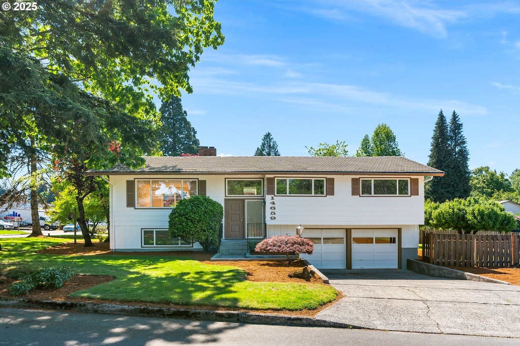 14659 SE Primrose Ave, Milwaukie, OR 97267 - raised ranch with a garage, driveway, and a chimney