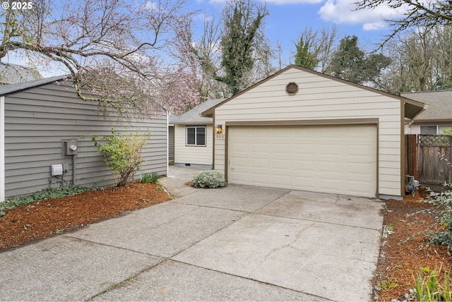 view of front of home featuring fence, an attached garage, concrete driveway, an outdoor structure, and crawl space