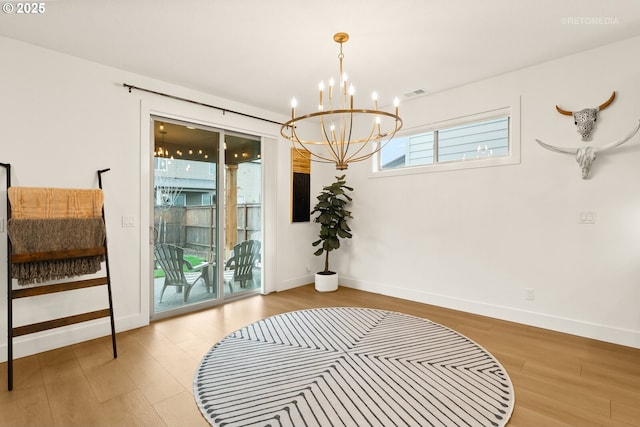 interior space featuring visible vents, baseboards, and wood finished floors