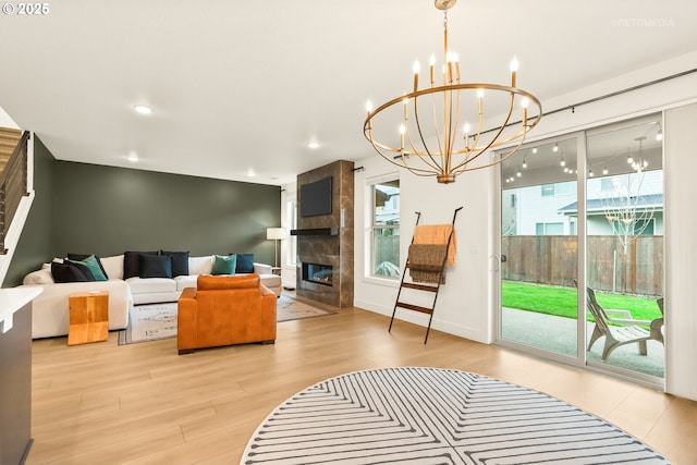 living area with recessed lighting, baseboards, wood finished floors, and a tile fireplace