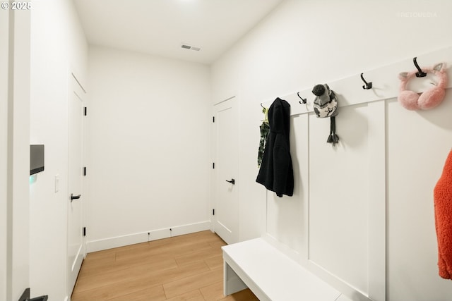 mudroom featuring light wood-style flooring and baseboards