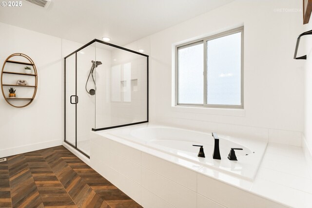 bathroom featuring visible vents, a shower stall, baseboards, and a garden tub