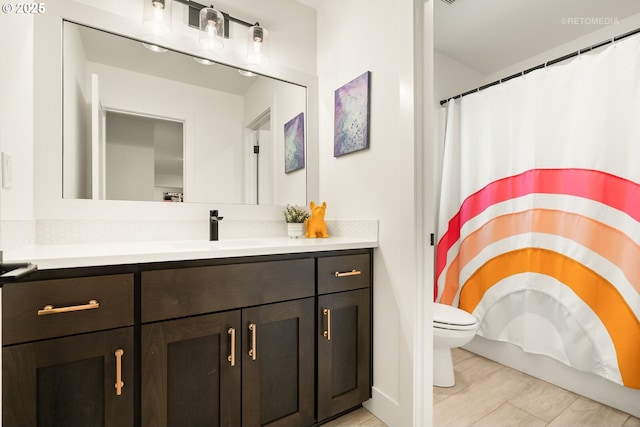 bathroom with curtained shower, toilet, and vanity