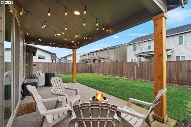 view of patio with a residential view, a fenced backyard, and an outdoor fire pit