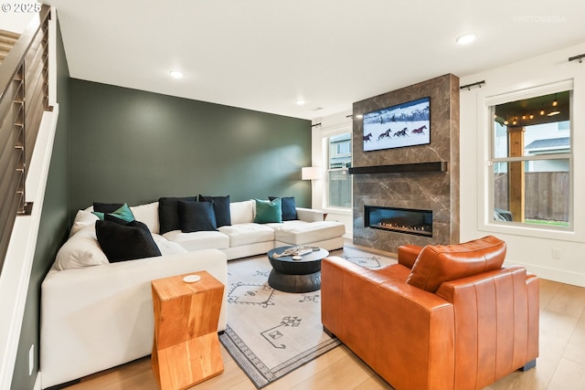 living area with a high end fireplace and recessed lighting