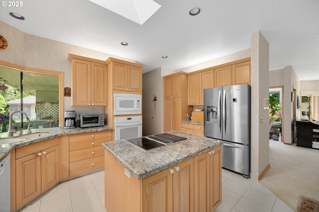 22750 SW Rosedale Rd, Beaverton, OR 97078 - kitchen featuring white appliances, a skylight, a kitchen island, light tile patterned flooring, and recessed lighting