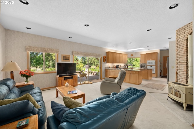 22750 SW Rosedale Rd, Beaverton, OR 97078 - living room featuring light colored carpet, wallpapered walls, a textured ceiling, and recessed lighting