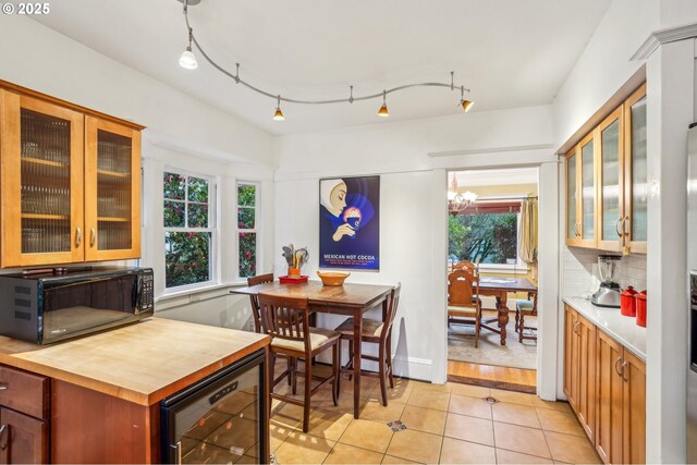 1917 NE Fremont St, Portland, OR 97212 - dining room featuring wine cooler, light tile patterned floors, and a chandelier