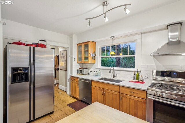 1917 NE Fremont St, Portland, OR 97212 - kitchen featuring stainless steel appliances, a sink, wall chimney exhaust hood, light countertops, and decorative backsplash