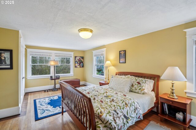 1917 NE Fremont St, Portland, OR 97212 - bedroom with wood finished floors, baseboards, and a textured ceiling