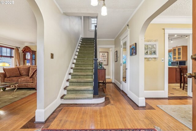 1917 NE Fremont St, Portland, OR 97212 - stairway with arched walkways, wood-type flooring, baseboards, plenty of natural light, and ornamental molding