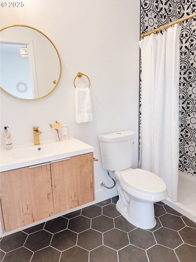 bathroom with tile patterned flooring, a shower stall, toilet, and vanity