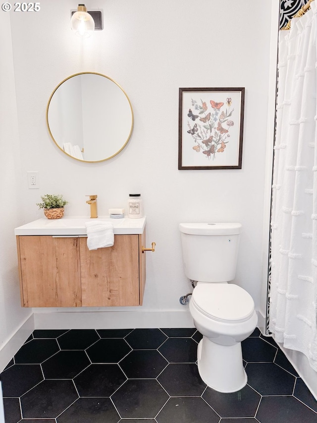 full bathroom with tile patterned floors, toilet, vanity, and baseboards