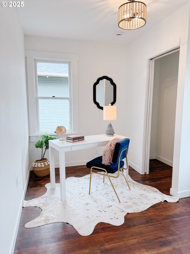 office featuring a chandelier, baseboards, and wood finished floors