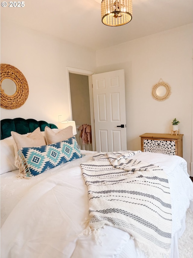 bedroom featuring an inviting chandelier