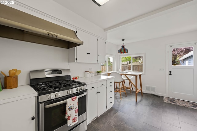 904 NE 78th Ave, Portland, OR 97213 - kitchen with stainless steel range with gas stovetop, light countertops, white cabinets, and wall chimney exhaust hood