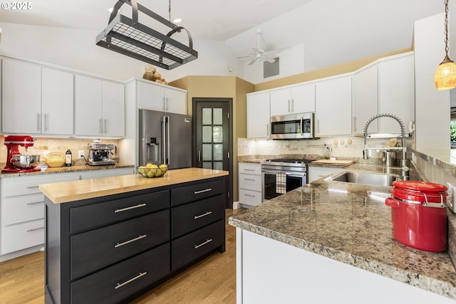 1575 Fairview Pl, Cottage Grove, OR 97424 - kitchen with high end appliances, backsplash, white cabinets, dark cabinets, and high vaulted ceiling