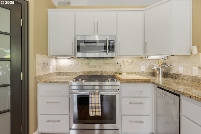 1575 Fairview Pl, Cottage Grove, OR 97424 - kitchen with appliances with stainless steel finishes, tasteful backsplash, white cabinetry, and light stone countertops