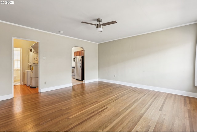 spare room with light hardwood / wood-style floors, ceiling fan, and ornamental molding