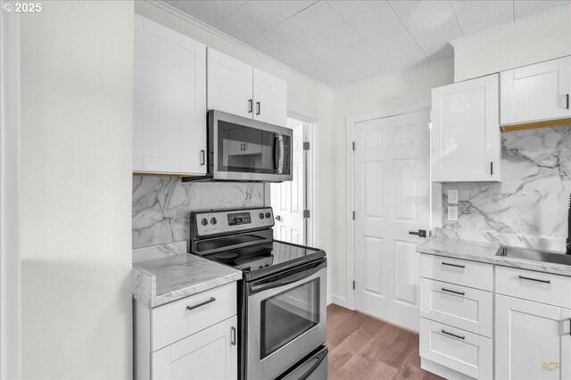 3114 Delaware St, Longview, WA 98632 - kitchen with white cabinetry, appliances with stainless steel finishes, and decorative backsplash