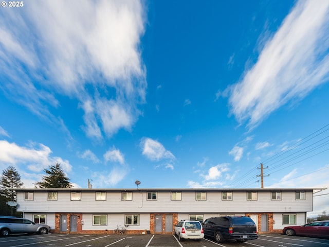 view of building exterior featuring uncovered parking