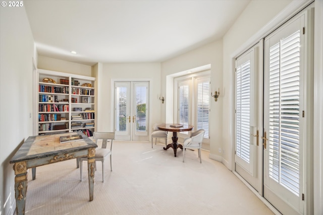 interior space with light carpet and french doors