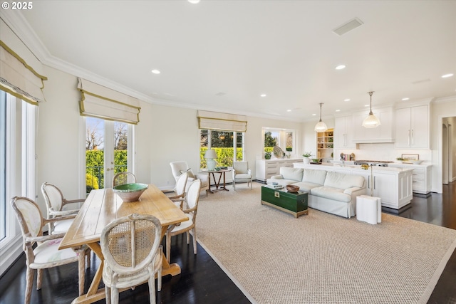 dining area with ornamental molding and a healthy amount of sunlight