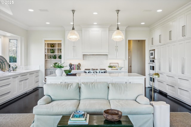 living room featuring sink and ornamental molding