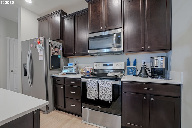 7110 NE 155th Pl, Vancouver, WA 98682 - kitchen featuring light countertops, light wood-type flooring, dark brown cabinetry, and stainless steel appliances