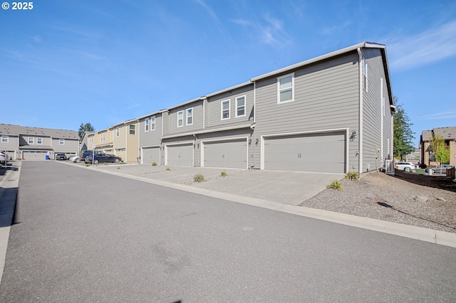 7110 NE 155th Pl, Vancouver, WA 98682 - exterior space featuring cooling unit, a residential view, an attached garage, and driveway