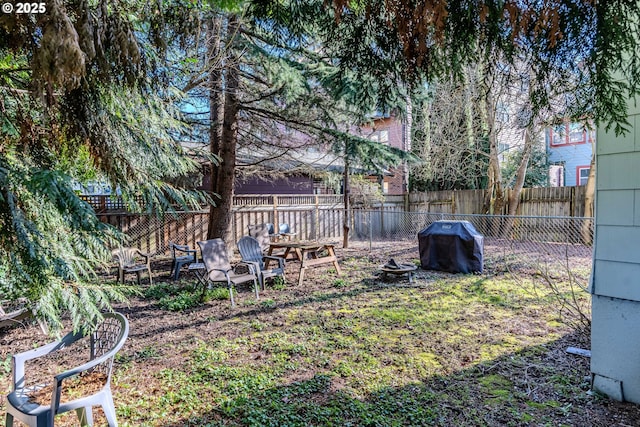 view of yard with a fire pit