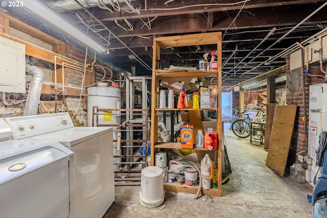 basement featuring water heater and washing machine and clothes dryer