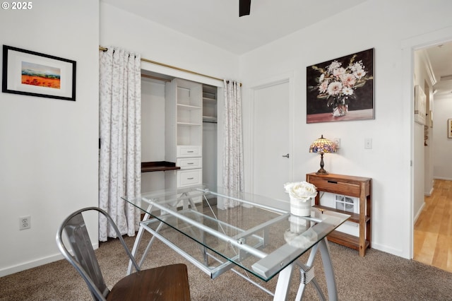 carpeted home office with ceiling fan