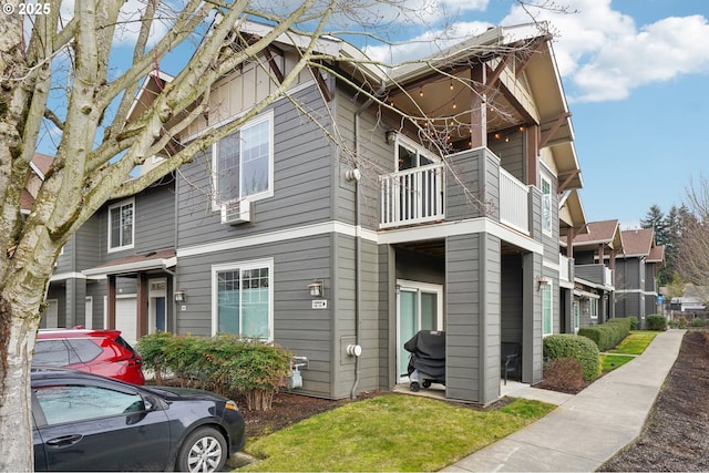 view of home's exterior with a yard and a balcony