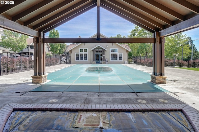 view of swimming pool featuring an outdoor structure and a patio