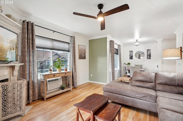 living room with crown molding, a wall unit AC, ceiling fan, and light wood-type flooring