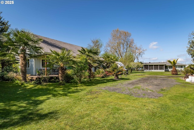 view of yard with a sunroom