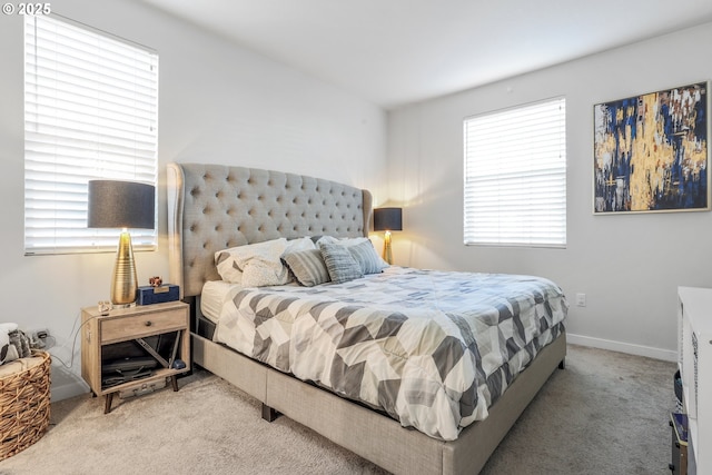 carpeted bedroom with multiple windows