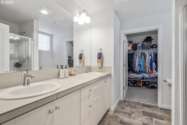 bathroom featuring an enclosed shower and vanity