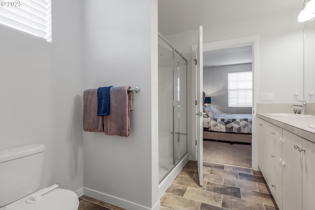 bathroom featuring toilet, vanity, and walk in shower