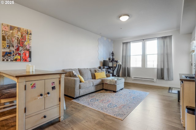 living room featuring light wood-type flooring and baseboard heating