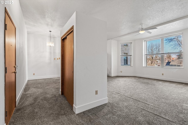 additional living space with ceiling fan with notable chandelier, a textured ceiling, and dark carpet