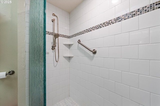 bathroom with tiled shower