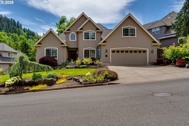 6111 Fernhill Loop, Springfield, OR 97478 - traditional home featuring a garage, stucco siding, driveway, and a front yard
