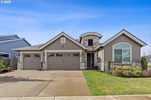 view of front of house with a garage, stone siding, driveway, and a front yard