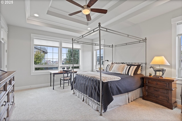 carpeted bedroom featuring a tray ceiling, recessed lighting, and baseboards