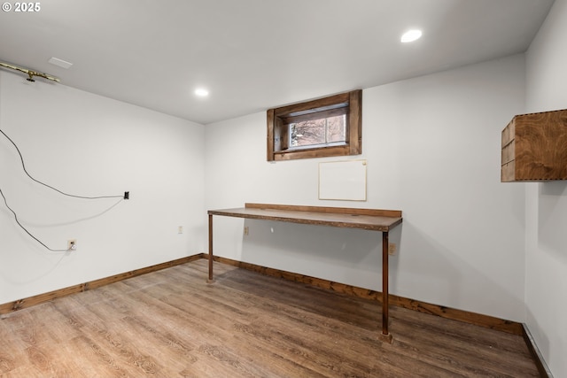 basement with baseboards, wood finished floors, and recessed lighting