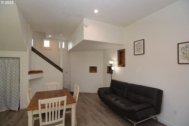 dining space with baseboards, wood finished floors, and recessed lighting