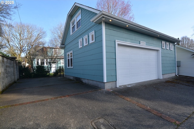 exterior space with driveway and fence